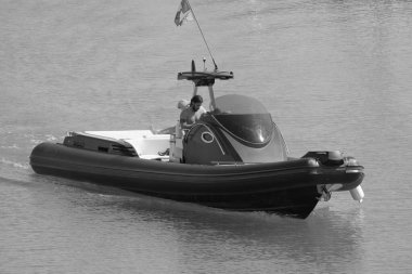 Italy, Sicily, Mediterranean Sea, Marina di Ragusa (Ragusa Province); 3 August 2022, men on a big rubber boat in the port - EDITORIAL