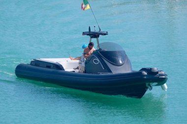 Italy, Sicily, Mediterranean Sea, Marina di Ragusa (Ragusa Province); 3 August 2022, men on a big rubber boat in the port - EDITORIAL