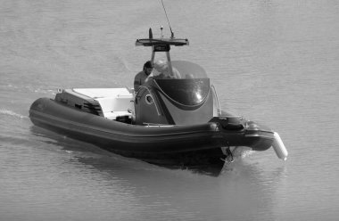 Italy, Sicily, Mediterranean Sea, Marina di Ragusa (Ragusa Province); 3 August 2022, men on a big rubber boat in the port - EDITORIAL