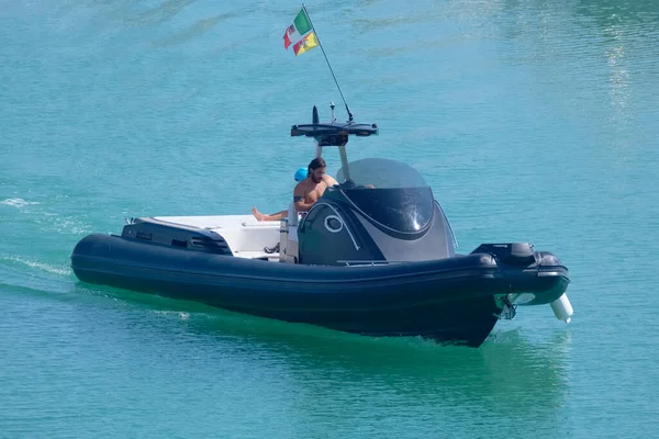 Italy, Sicily, Mediterranean Sea, Marina di Ragusa (Ragusa Province); 3 August 2022, men on a big rubber boat in the port - EDITORIAL