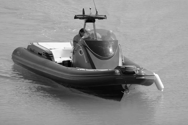 Italy, Sicily, Mediterranean Sea, Marina di Ragusa (Ragusa Province); 3 August 2022, men on a big rubber boat in the port - EDITORIAL