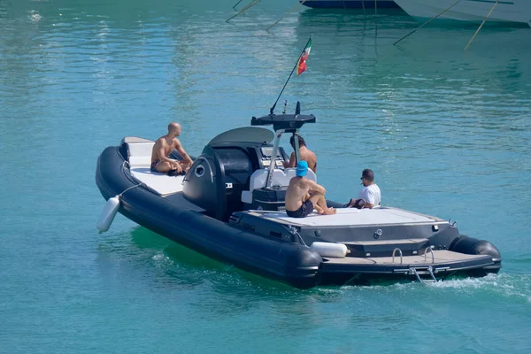 Italy, Sicily, Mediterranean Sea, Marina di Ragusa (Ragusa Province); 3 August 2022, men on a big rubber boat in the port - EDITORIAL