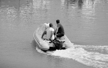 Italy, Sicily, Mediterranean Sea, Marina di Ragusa (Ragusa Province); 4 August 2022, men on a rubber boat in the port - EDITORIAL