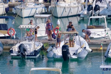 Italy, Sicily, Mediterranean sea, Marina di Ragusa (Ragusa Province); 4 August 2022, people, motor boats and luxury yachts in the port - EDITORIAL