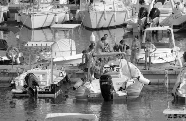 Italy, Sicily, Mediterranean sea, Marina di Ragusa (Ragusa Province); 4 August 2022, people, motor boats and luxury yachts in the port - EDITORIAL