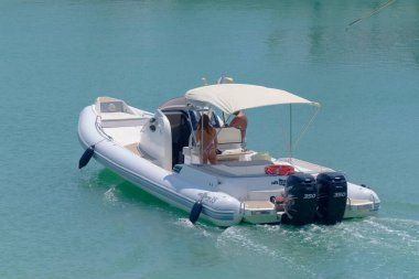 Italy, Sicily, Mediterranean Sea, Marina di Ragusa (Ragusa Province); 5 August 2022, couple on a big rubber boat in the port - EDITORIAL