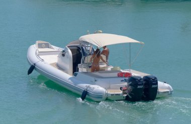 Italy, Sicily, Mediterranean Sea, Marina di Ragusa (Ragusa Province); 5 August 2022, couple on a big rubber boat in the port - EDITORIAL