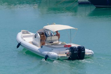 Italy, Sicily, Mediterranean Sea, Marina di Ragusa (Ragusa Province); 5 August 2022, couple on a big rubber boat in the port - EDITORIAL