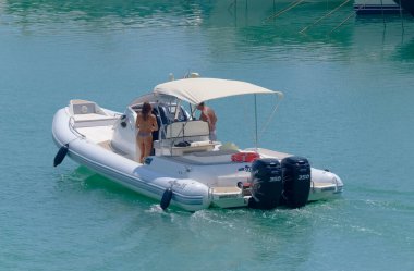 Italy, Sicily, Mediterranean Sea, Marina di Ragusa (Ragusa Province); 5 August 2022, couple on a big rubber boat in the port - EDITORIAL