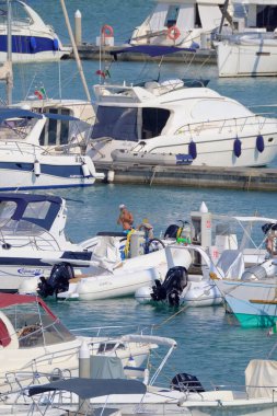 Italy, Sicily, Mediterranean sea, Marina di Ragusa (Ragusa Province); 5 August 2022, people, motor boats and luxury yachts in the port - EDITORIAL