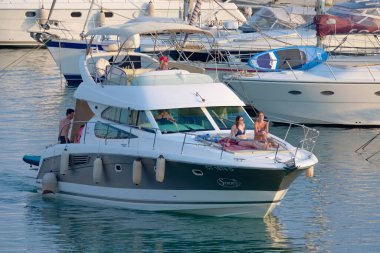 Italy, Sicily, Mediterranean Sea, Marina di Ragusa (Ragusa Province); 7 August 2022, people on a luxury yacht in the port - EDITORIAL