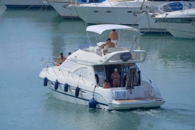 Italy, Sicily, Mediterranean Sea, Marina di Ragusa (Ragusa Province); 8 August 2022, people on a luxury yacht in the port - EDITORIAL