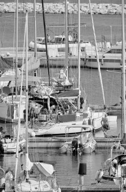 Italy, Sicily, Mediterranean Sea, Marina di Ragusa (Ragusa Province); 8 August 2022, people on a sailing boat, motor boats and luxury yachts in the port - EDITORIAL
