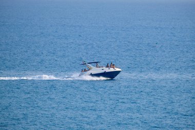 Italy, Sicily, Mediterranean Sea, Marina di Ragusa (Ragusa Province); people on a motor boat in the sea 