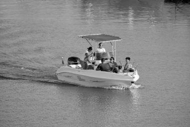 Italy, Sicily, Mediterranean Sea, Marina di Ragusa (Ragusa Province); 8 August 2022, people on a motor boat in the port - EDITORIAL