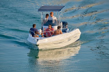 Italy, Sicily, Mediterranean Sea, Marina di Ragusa (Ragusa Province); 8 August 2022, people on a motor boat in the port - EDITORIAL