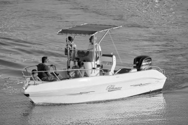 Italy, Sicily, Mediterranean Sea, Marina di Ragusa (Ragusa Province); 8 August 2022, people on a motor boat in the port - EDITORIAL