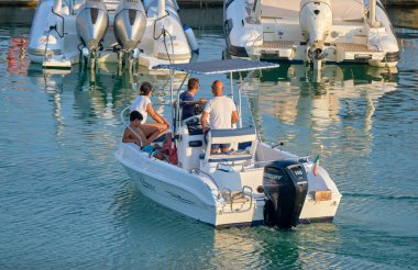 Italy, Sicily, Mediterranean Sea, Marina di Ragusa (Ragusa Province); 8 August 2022, people on a motor boat in the port - EDITORIAL