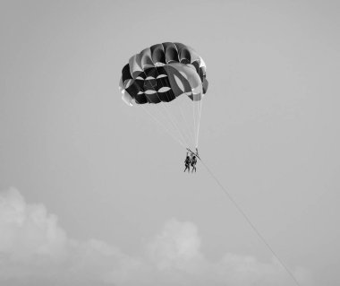 Italy, Sicily, Mediterranean Sea, Marina di Ragusa (Ragusa Province); girls parasailing off the coast 