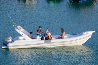 Italy, Sicily, Mediterranean Sea, Marina di Ragusa (Ragusa Province); 14 August 2022, people on a rubber boat in the port - EDITORIAL