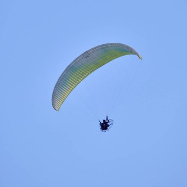 Italy; Sicily, man flying on a powered paraglider 