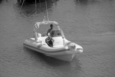 Italy, Sicily, Mediterranean Sea, Marina di Ragusa (Ragusa Province); 16 August 2022, man on a rubber boat in the port - EDITORIAL