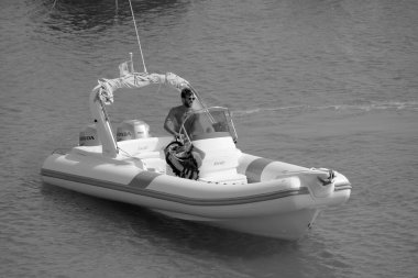 Italy, Sicily, Mediterranean Sea, Marina di Ragusa (Ragusa Province); 16 August 2022, man on a rubber boat in the port - EDITORIAL