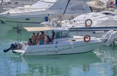 Italy, Sicily, Mediterranean Sea, Marina di Ragusa (Ragusa Province); 25 August 2022, people on a luxury yacht in the port - EDITORIAL