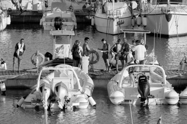 Italy, Sicily, Mediterranean sea, Marina di Ragusa (Ragusa Province); 25 August 2022, people, motor boats and luxury yachts in the port - EDITORIAL