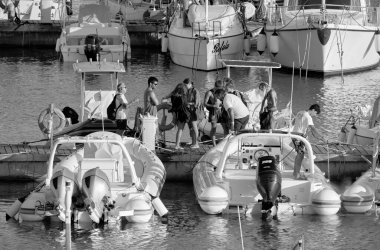 Italy, Sicily, Mediterranean sea, Marina di Ragusa (Ragusa Province); 25 August 2022, people, motor boats and luxury yachts in the port - EDITORIAL