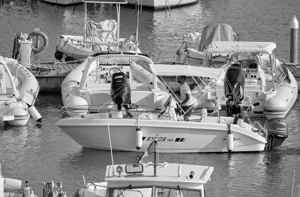 Italy, Sicily, Mediterranean Sea, Marina di Ragusa (Ragusa Province); 26 August 2022, people on a motor boat and luxury yachts in the port - EDITORIAL