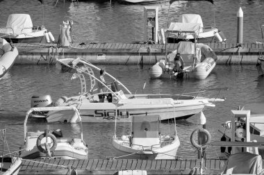 Italy, Sicily, Mediterranean Sea, Marina di Ragusa (Ragusa Province); 27 August 2022, man on a motor boat in the port - EDITORIAL