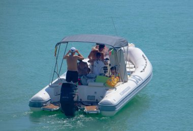 Italy, Sicily, Mediterranean Sea, Marina di Ragusa (Ragusa Province); 28 August 2022, people on a rubber boat in the port - EDITORIAL