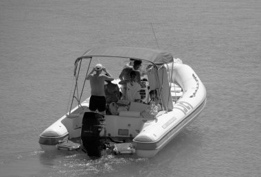 Italy, Sicily, Mediterranean Sea, Marina di Ragusa (Ragusa Province); 28 August 2022, people on a rubber boat in the port - EDITORIAL