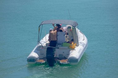 Italy, Sicily, Mediterranean Sea, Marina di Ragusa (Ragusa Province); 28 August 2022, people on a rubber boat in the port - EDITORIAL