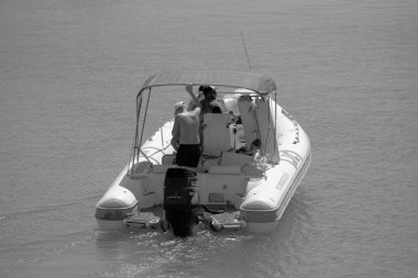 Italy, Sicily, Mediterranean Sea, Marina di Ragusa (Ragusa Province); 28 August 2022, people on a rubber boat in the port - EDITORIAL