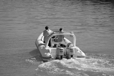 Italy, Sicily, Mediterranean Sea, Marina di Ragusa (Ragusa Province); 28 August 2022, people on a rubber boat in the port - EDITORIAL