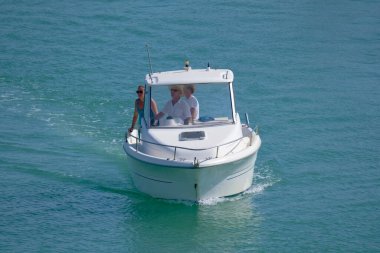 Italy, Sicily, Mediterranean Sea, Marina di Ragusa (Ragusa Province); 28 August 2022, people on a motor boat in the port - EDITORIAL