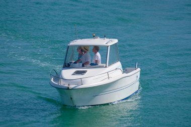 Italy, Sicily, Mediterranean Sea, Marina di Ragusa (Ragusa Province); 28 August 2022, people on a motor boat in the port - EDITORIAL