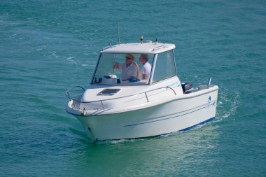 Italy, Sicily, Mediterranean Sea, Marina di Ragusa (Ragusa Province); 28 August 2022, people on a motor boat in the port - EDITORIAL