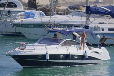 Italy, Sicily, Mediterranean Sea, Marina di Ragusa (Ragusa Province); 28 August 2022, people on a luxury yacht in the port - EDITORIAL