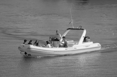 Italy, Sicily, Mediterranean Sea, Marina di Ragusa (Ragusa Province); 28 August 2022, people on a rubber boat in the port - EDITORIAL