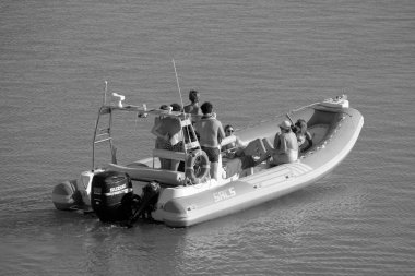 Italy, Sicily, Mediterranean Sea, Marina di Ragusa (Ragusa Province); 28 August 2022, people on a rubber boat in the port - EDITORIAL