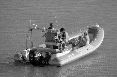Italy, Sicily, Mediterranean Sea, Marina di Ragusa (Ragusa Province); 28 August 2022, people on a rubber boat in the port - EDITORIAL