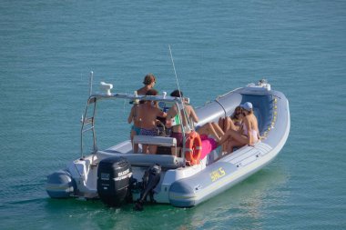Italy, Sicily, Mediterranean Sea, Marina di Ragusa (Ragusa Province); 28 August 2022, people on a rubber boat in the port - EDITORIAL