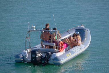 Italy, Sicily, Mediterranean Sea, Marina di Ragusa (Ragusa Province); 28 August 2022, people on a rubber boat in the port - EDITORIAL