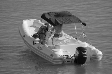 Italy, Sicily, Mediterranean Sea, Marina di Ragusa (Ragusa Province); 28 August 2022, couple on a rubber boat in the port - EDITORIAL