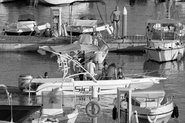Italy, Sicily, Mediterranean Sea, Marina di Ragusa (Ragusa Province); 28 August 2022, people on a motor boat in the port - EDITORIAL