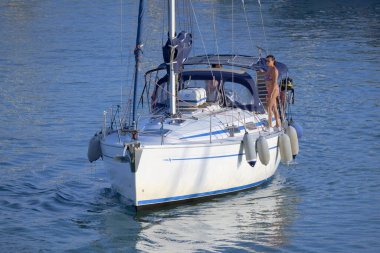 Italy, Sicily, Mediterranean Sea, Marina di Ragusa (Ragusa Province); 28 August 2022, couple on a sailing boat in the port - EDITORIAL