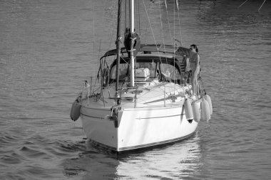Italy, Sicily, Mediterranean Sea, Marina di Ragusa (Ragusa Province); 28 August 2022, couple on a sailing boat in the port - EDITORIAL